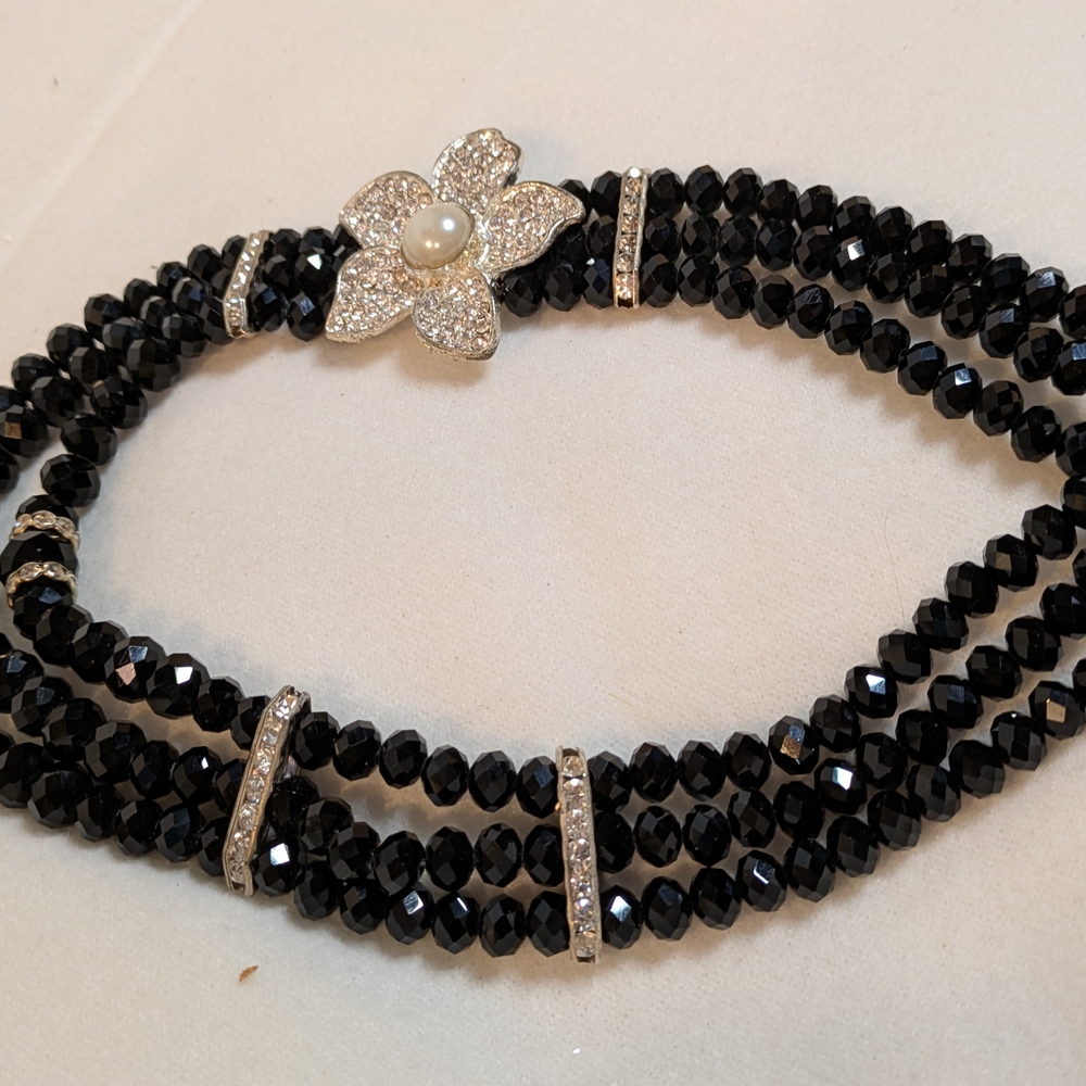 Elegant Black Beaded Necklace with Silver Flower Clasp